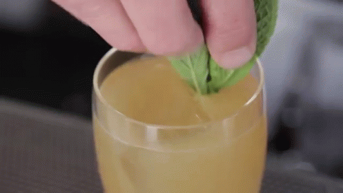 Adding Mint Leaf To Juice GIF