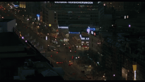 Aerial View of City at Night With Victoria-Versicherungen on Building