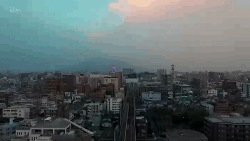 Aerial View of City at Sunset With Train