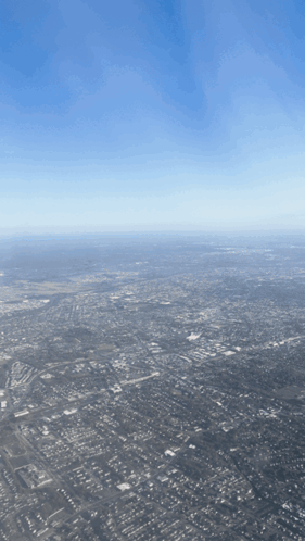 Aerial View of Large City With Blue Sky