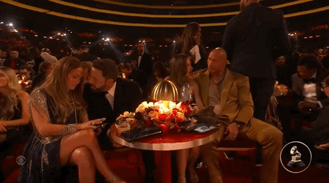 Affleck And Rock Sitting Beside Couples GIF