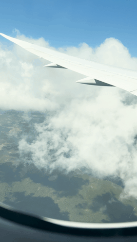 Airplane Wing Flying Through Clouds