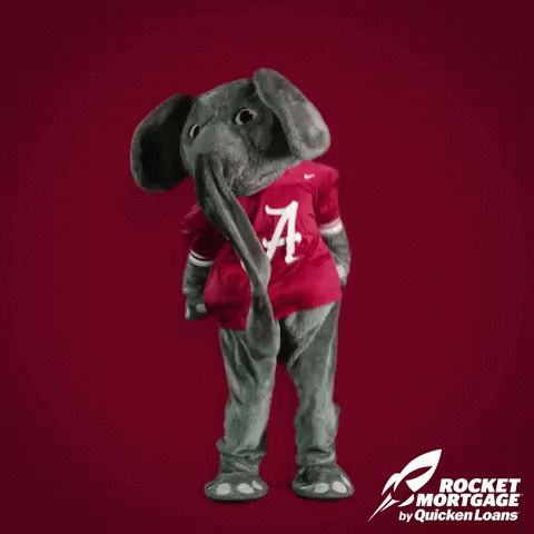 Alabama Mascot Standing In Front Of Red Background Saying Alabama Wins GIF