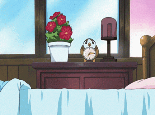 Alarm Clock On Nightstand Next To Plant GIF
