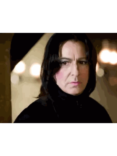 albus dumbledore from harry potter is wearing a wig and a hat and has a surprised look on his face .