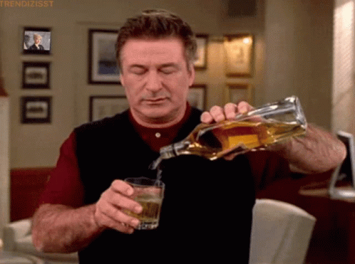 Alec Baldwin Pouring Whiskey On The Glass GIF