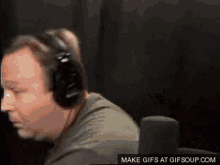 Alex Jones Holding Gun Playful Threat GIF