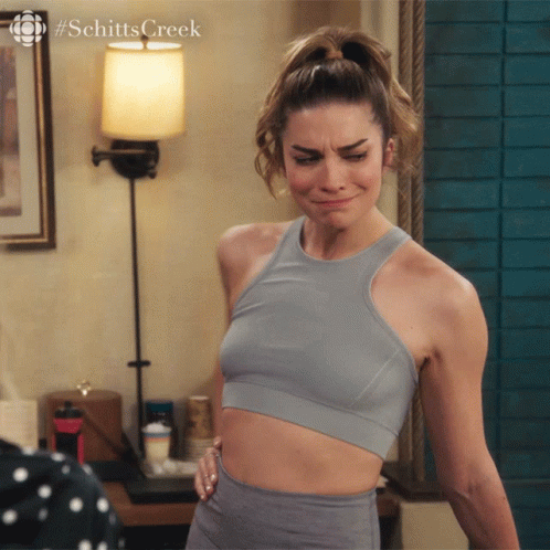 Alexis Rose Checking Her Figure GIF