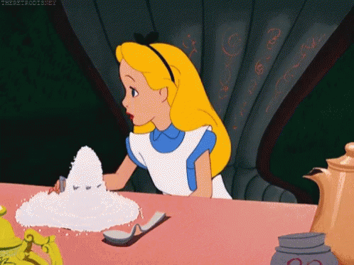 Alice From Alice In Wonderland Is Sitting At A Table With A Pile Of Sugar GIF