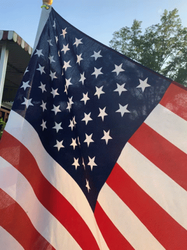 American Flag Flying in Front of White Awning