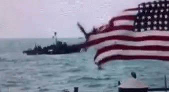 American Flag Flying Near Ship In Ocean GIF