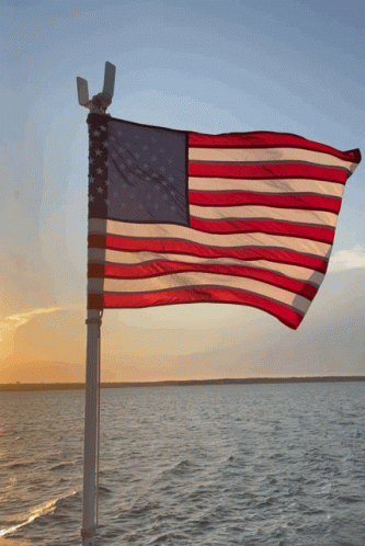 American Flag Over Water At Sunset GIF