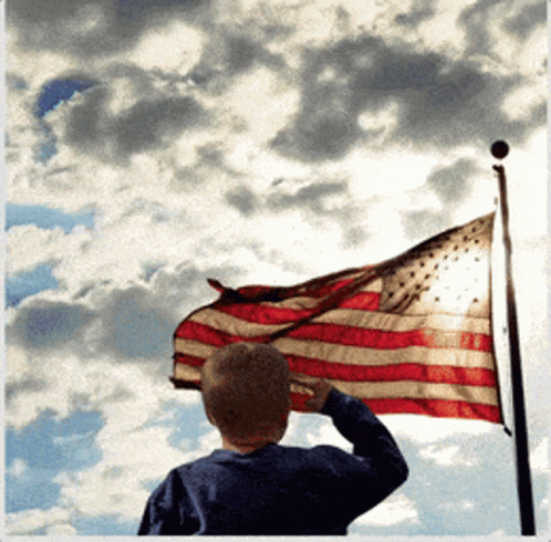 American Flag Waving In Wind Against Blue Sky
