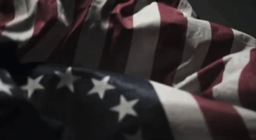 American Flag Waving In Wind In Dark Room GIF