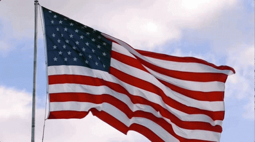 American Flag Waving in Wind With Cloudy Sky