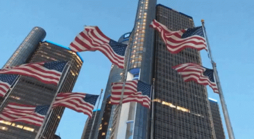 American Flags Flying in Front of Tall Building