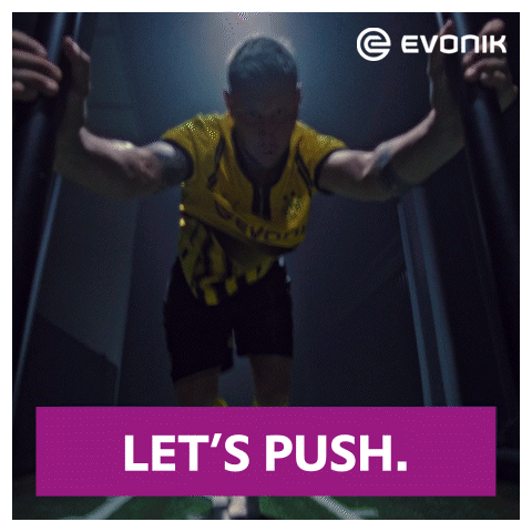An Ad For Evonik Shows A Man In A Yellow And Black Uniform GIF