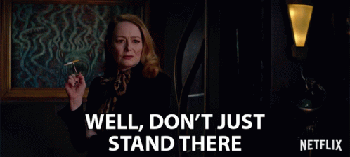 An Ad For Netflix Shows A Woman Smoking A Cigarette And Says Well Don 'T Just Stand There GIF