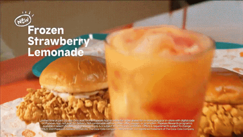 An Advertisement For Frozen Strawberry Lemonade Shows A Chicken Sandwich And A Glass Of Lemonade GIF