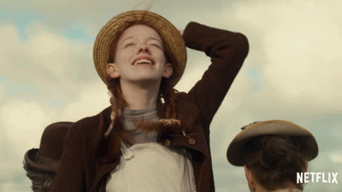An Advertisement For Netflix Shows A Girl In A Straw Hat Laughing GIF