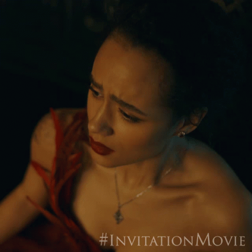 An Advertisement For The Invitation Movie Features A Woman In A Red Dress And Necklace GIF