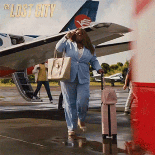 Woman In Blue Suit Carrying Suitcase Lost City GIF