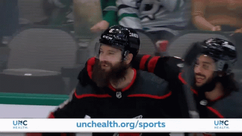 An Advertisement For Unc Health Shows Hockey Players On The Ice GIF