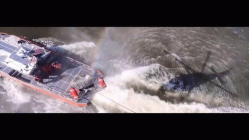 An Aerial View Of A Boat Going Through A Body Of Water GIF