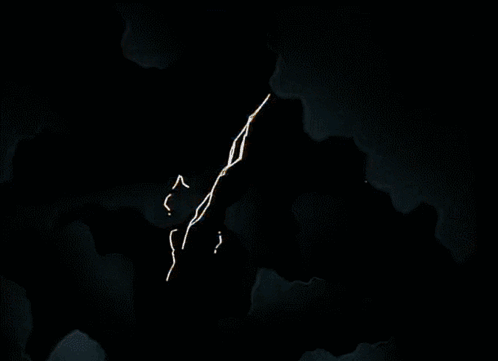 An Aerial View Of A Building With A Few Windows Lit Up At Night GIF