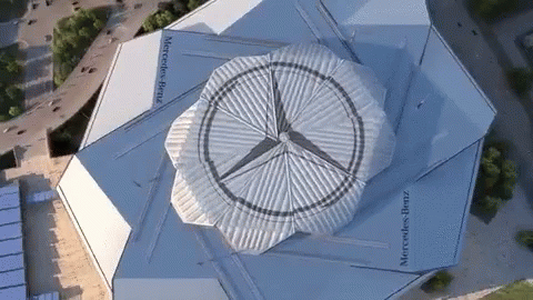 An Aerial View Of A Building With Mercedes Benz Written On It GIF