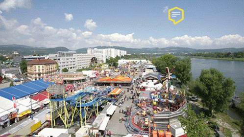 An Aerial View Of A Carnival With A Yellow Speech Bubble That Says ' E ' On It GIF