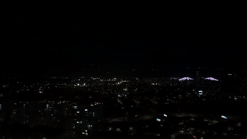 An Aerial View Of A City At Night With A Lot Of Lights On GIF