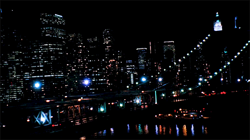 An Aerial View Of A City At Night With A Sign That Says ' Empire ' On It GIF