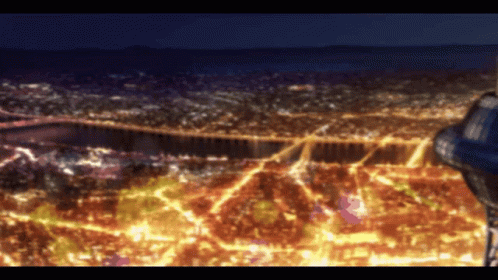 An Aerial View Of A City At Night With Lots Of Lights GIF