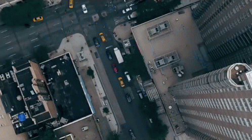 An Aerial View Of A City Street With A Building That Has The Letters Bb On It GIF