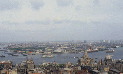 An Aerial View Of A City With A Clock Tower In The Middle Of The Water GIF