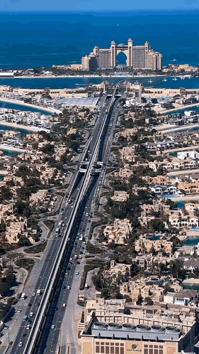An Aerial View Of A City With A Large Hotel In The Background GIF
