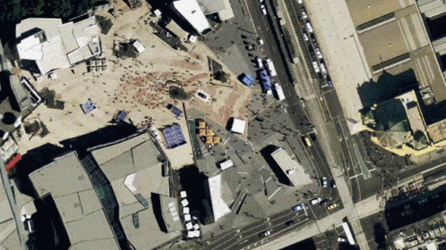 An Aerial View Of A City With A Lot Of Buildings And Streets GIF