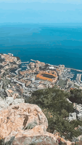 An Aerial View Of A City With A Stadium In The Middle GIF