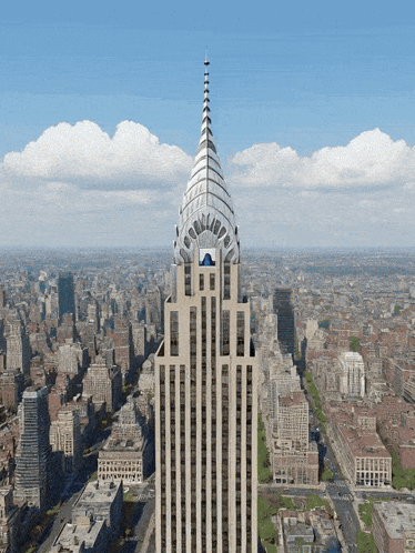 An Aerial View Of A City With A Tall Building In The Foreground GIF