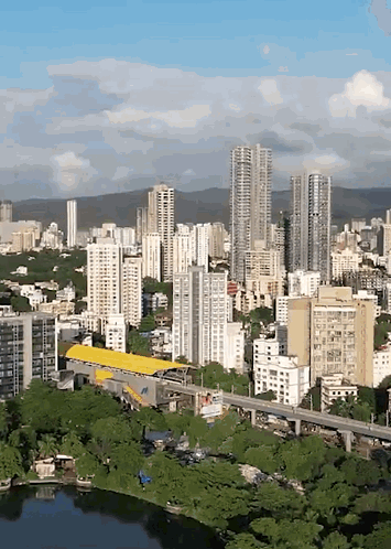 An Aerial View Of A City With Tall Buildings And Trees GIF