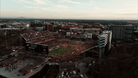an aerial view of a football stadium with a mountain dew billboard