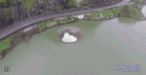 An Aerial View Of A Lake With A Hole In The Middle Of It GIF