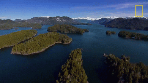 An Aerial View Of A Lake With Mountains In The Background And A National Geographic Logo GIF