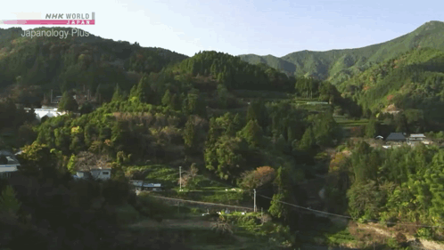 An Aerial View Of A Lush Green Hillside With Nhk World Japanology Plus In The Upper Right Corner GIF