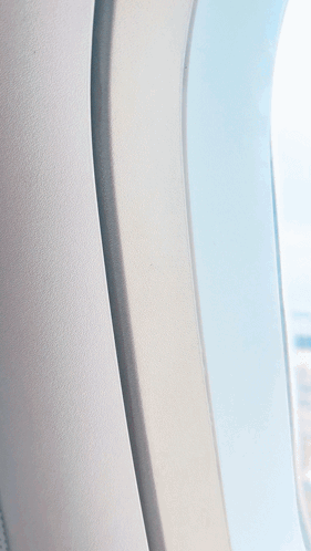 An Aerial View Of A Parking Lot From A Plane Window GIF