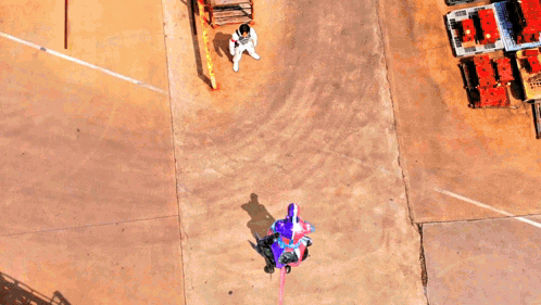 an aerial view of a person standing in front of a purple square