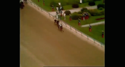 An Aerial View Of A Race Track With Horses And Jockeys . GIF