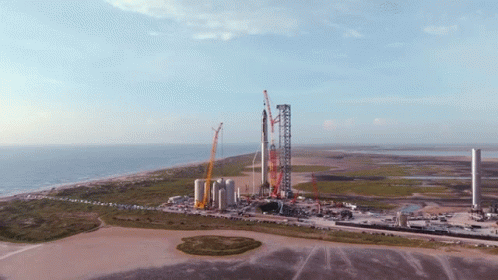 An Aerial View Of A Rocket Being Built On The Beach GIF