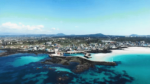 An Aerial View Of A Small Town On A Small Island In The Middle Of The Ocean GIF